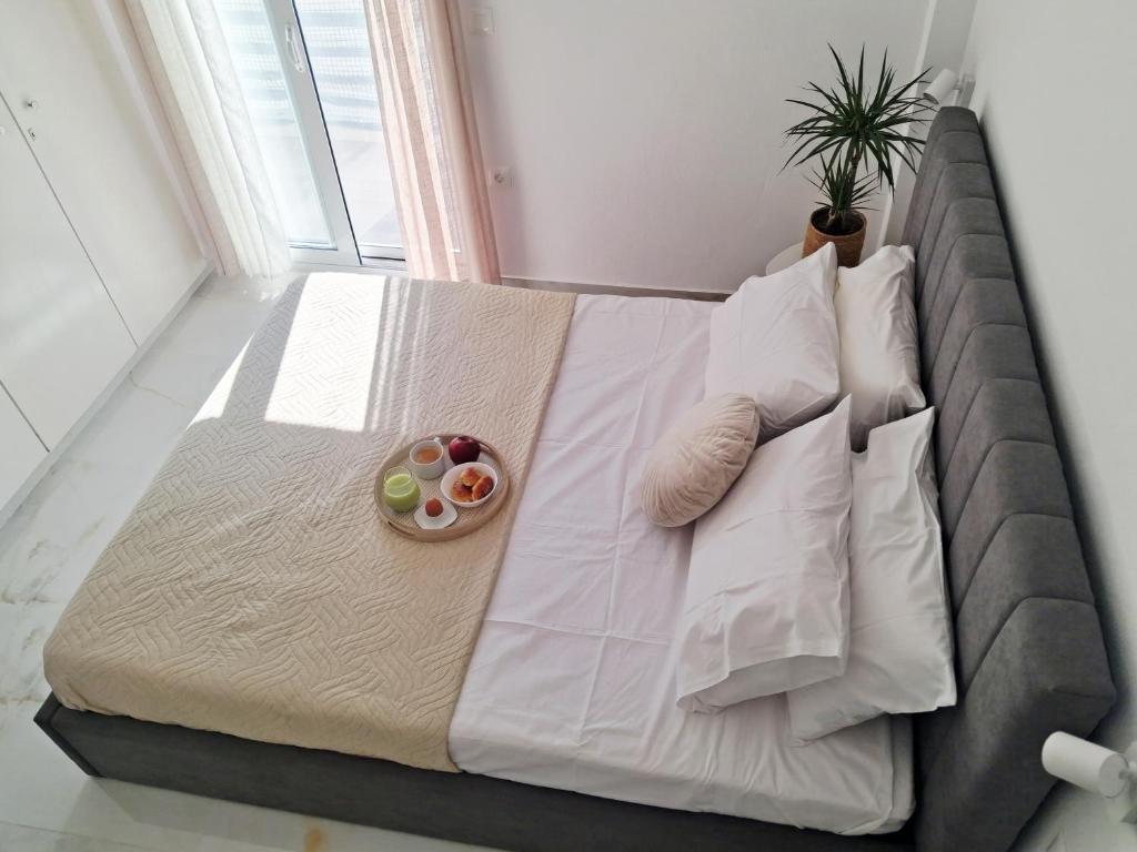 a large bed in a room with a plant on it at Rodini Home Ylia - Rhodes in Rhodes Town