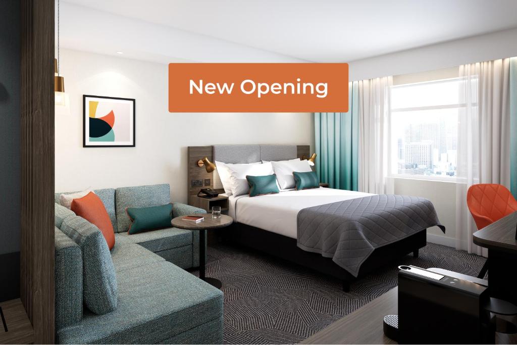 a hotel room with a bed and a couch at Holiday Inn Ratingen - City by IHG in Ratingen