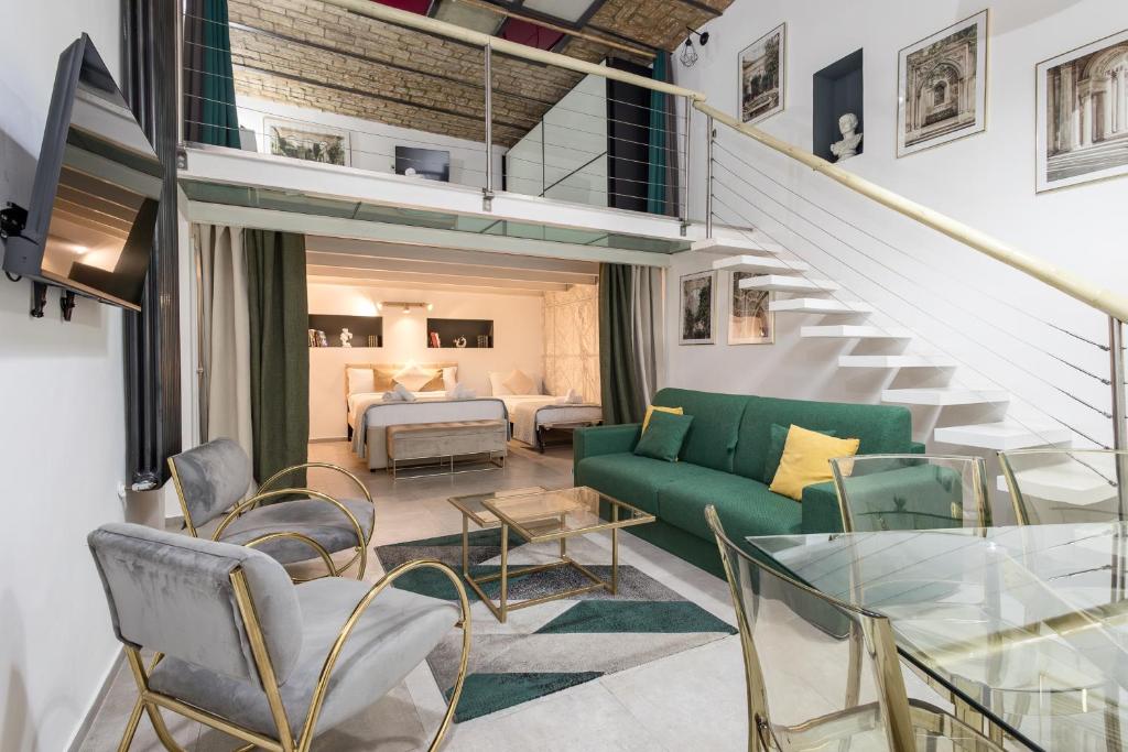 a living room with a green couch and chairs at DrsRome - Colosseum Loft in Rome