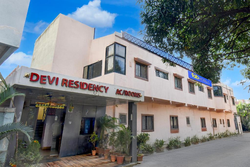 a building with a sign that reads dev residency kalore at FabHotel Devi Residency Wakad in Pune