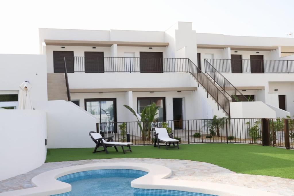 a villa with a swimming pool and a house at La Herrada Home in Los Montesinos