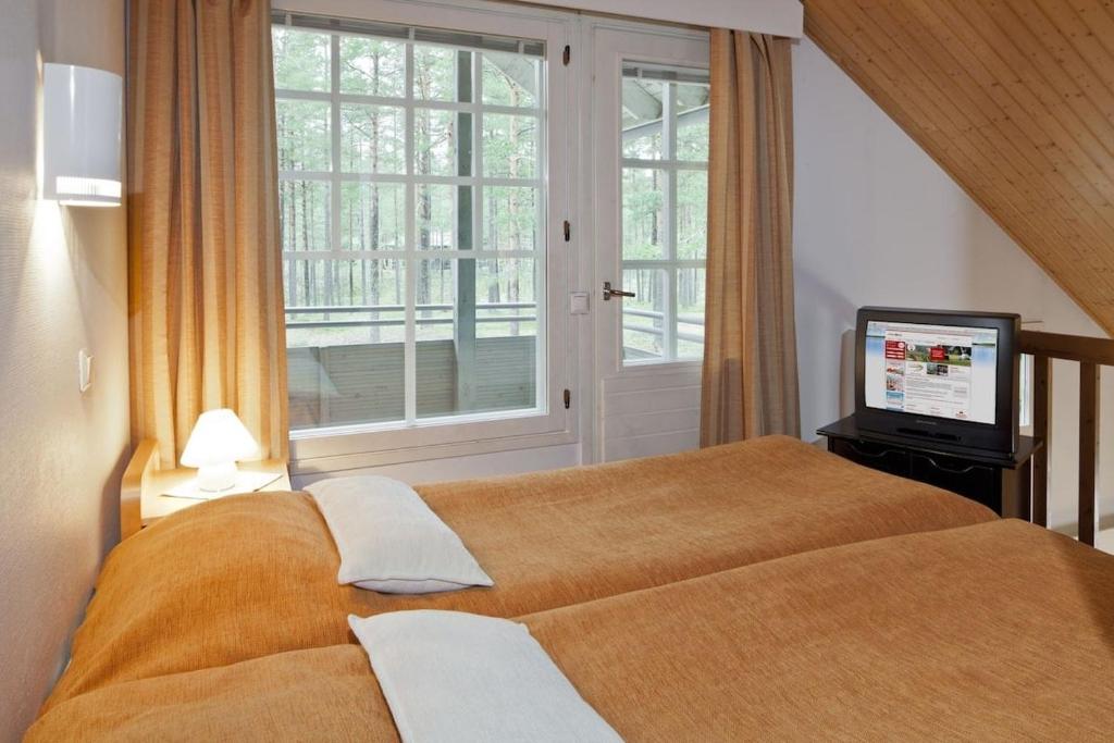 Postel nebo postele na pokoji v ubytování cottage studio with sauna and Mezzanine