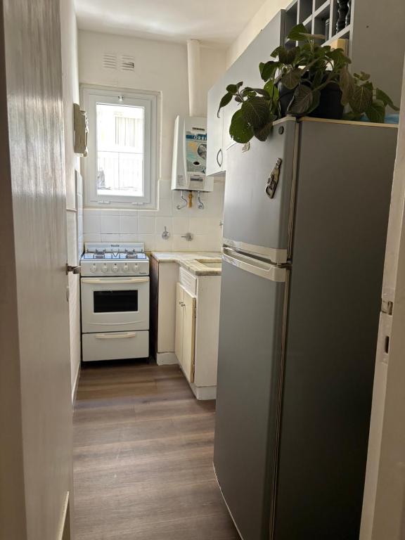 a kitchen with a refrigerator and a stove at Departamento frente al casino in Mar del Plata