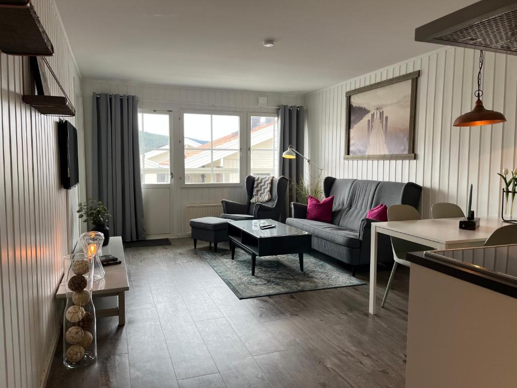 a living room with a couch and a table at Åre Stay- Åregårdarna 426 in Åre