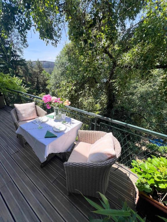 a wooden deck with a table and chairs on it at Altstadt Elegance in Graz Ostbahnhof
