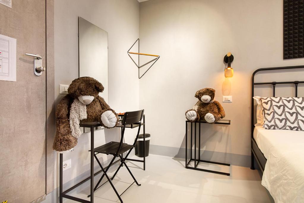 two teddy bears sitting on high chairs in a bedroom at Residenza Tor Vergata 2025 in Rome