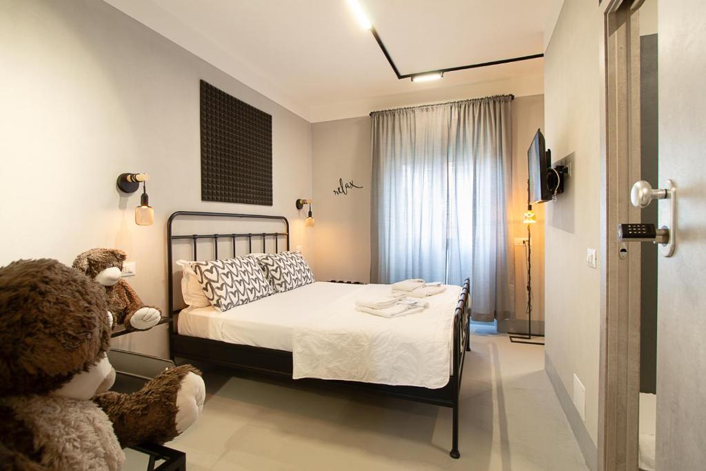 a bedroom with a bed and a teddy bear in a chair at Residenza Tor Vergata 2025 in Rome
