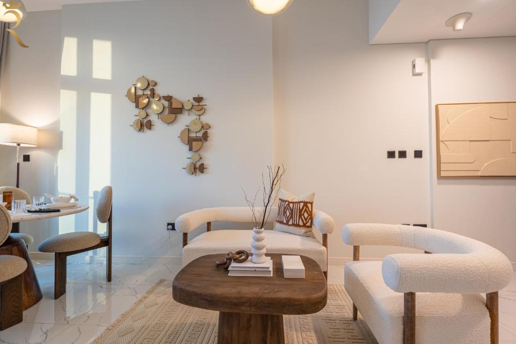 a living room with a table and chairs at Bright 1BR with Balcony the Gate, Masdar City in Abu Dhabi