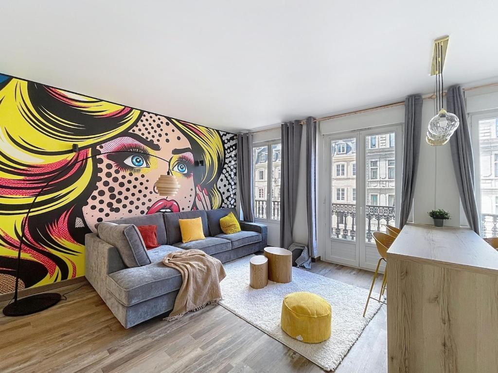 a living room with a mural of a woman at Mariani Place to Be in St Etienne in Saint-Étienne