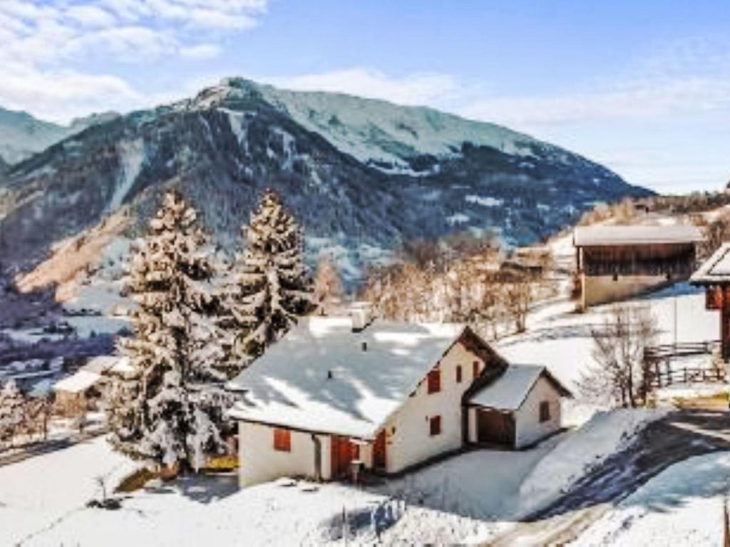 a house in the snow with a mountain in the background at Apartment Casa Foppa by Interhome in Somvix