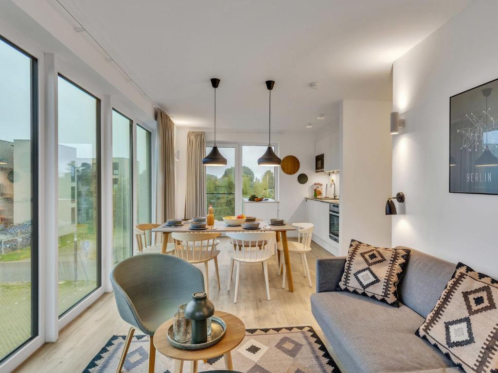 a living room with a couch and a table at Apartment Imort by Interhome in Lembruch