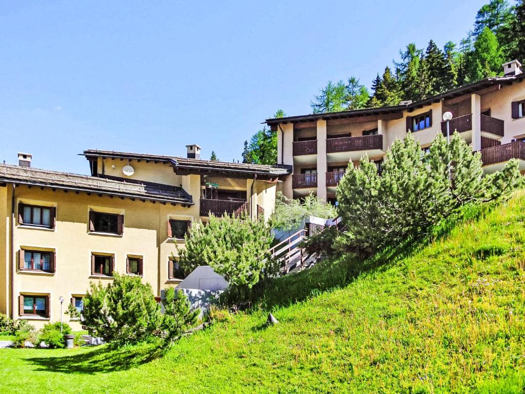 a building on the side of a hill with trees at Apartment Residenza Chesa Margun 33-1 by Interhome in Surlej