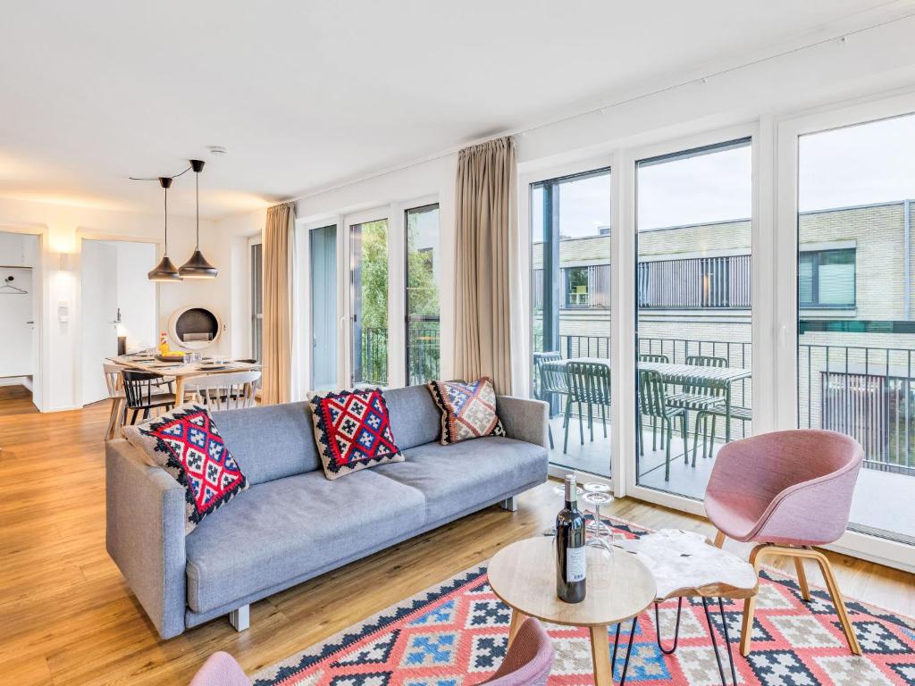a living room with a couch and a large window at Apartment Seeidyll by Interhome in Lembruch