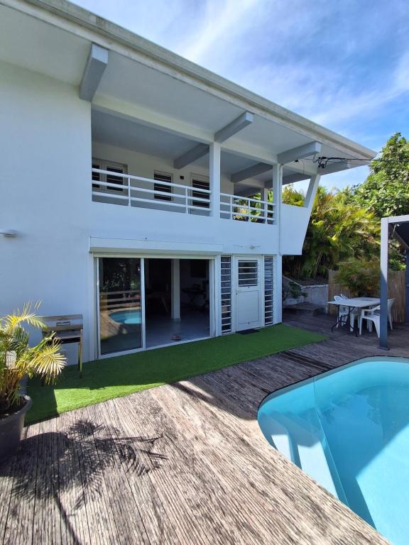 a villa with a swimming pool and a house at Villa PERGOLA in Fort-de-France