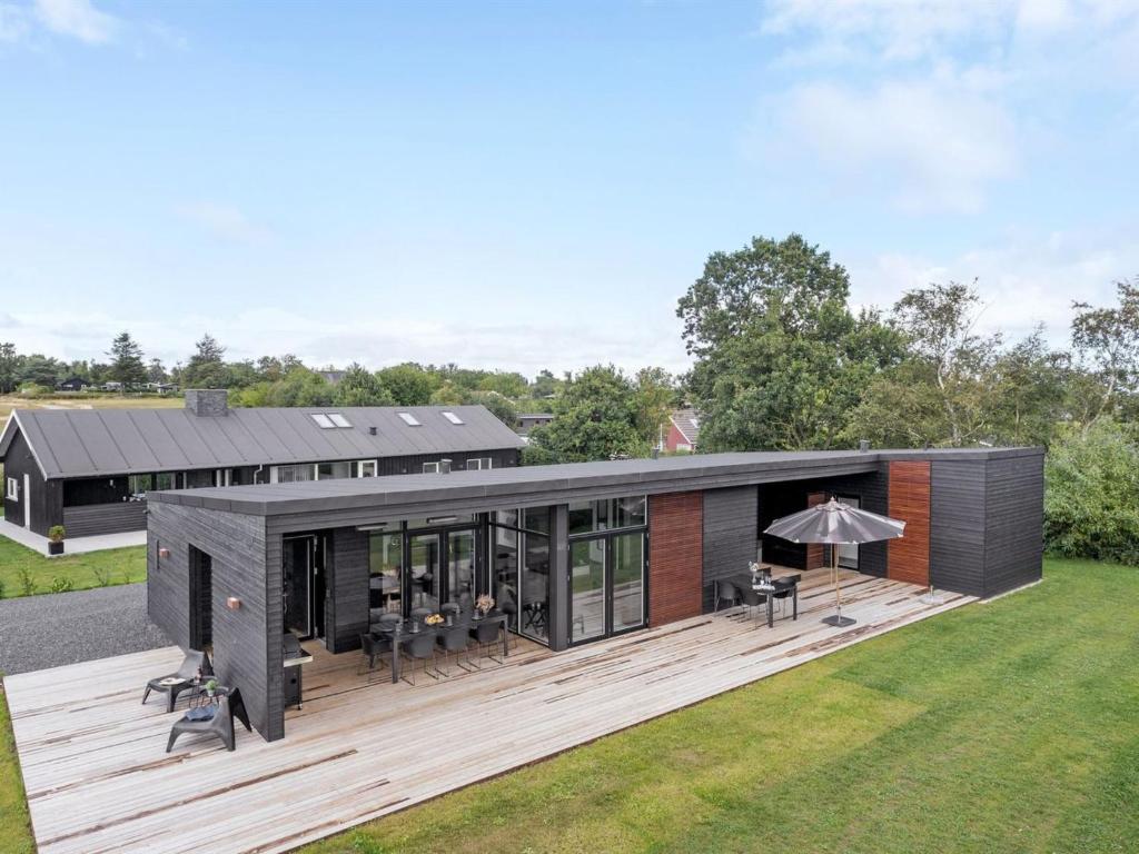 a modular home with a deck and a house at Holiday Home Emelina - 300m from the sea by Interhome in Rude