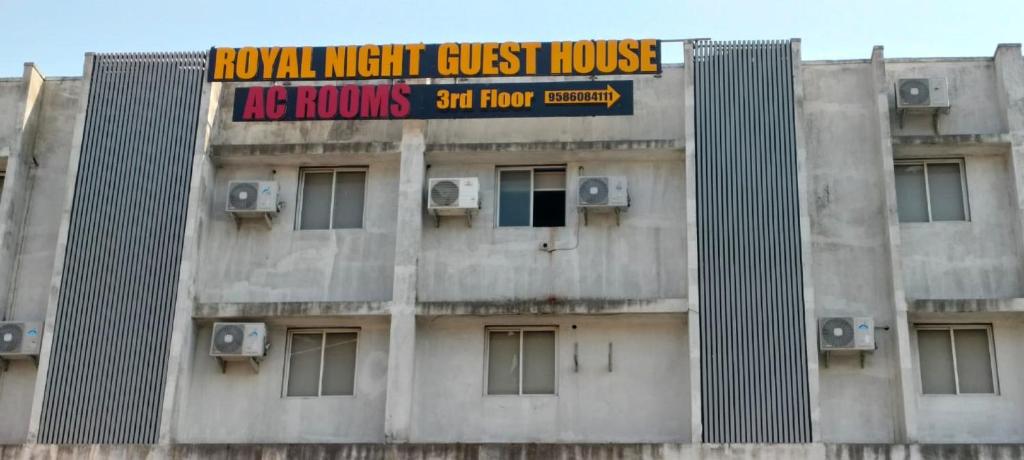 a building with a sign on top of it at Hotel Royal Night in Daman