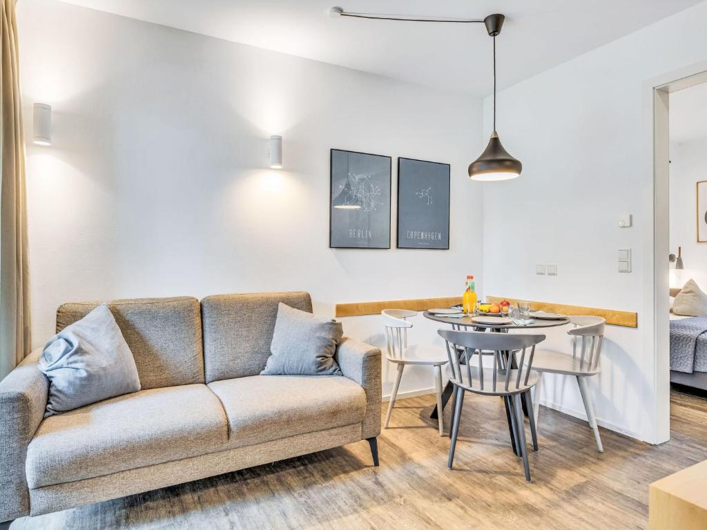 a living room with a couch and a table at Apartment Seeruhe by Interhome in Lembruch