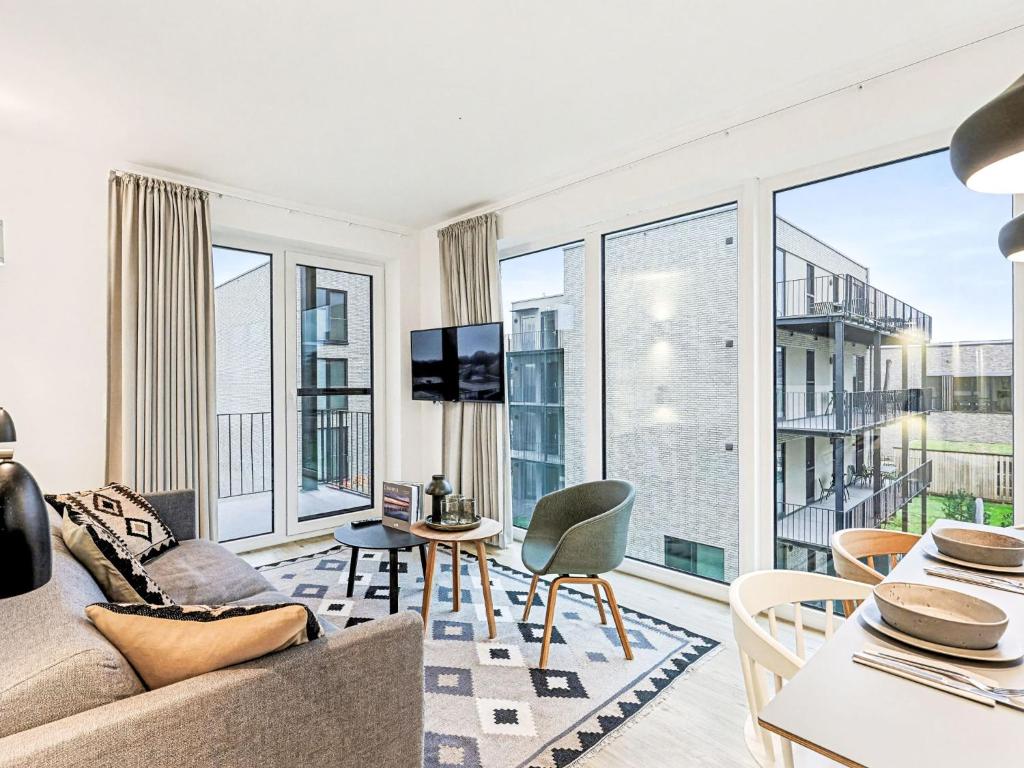 a living room with a couch and a table at Apartment Fiddy by Interhome in Lembruch