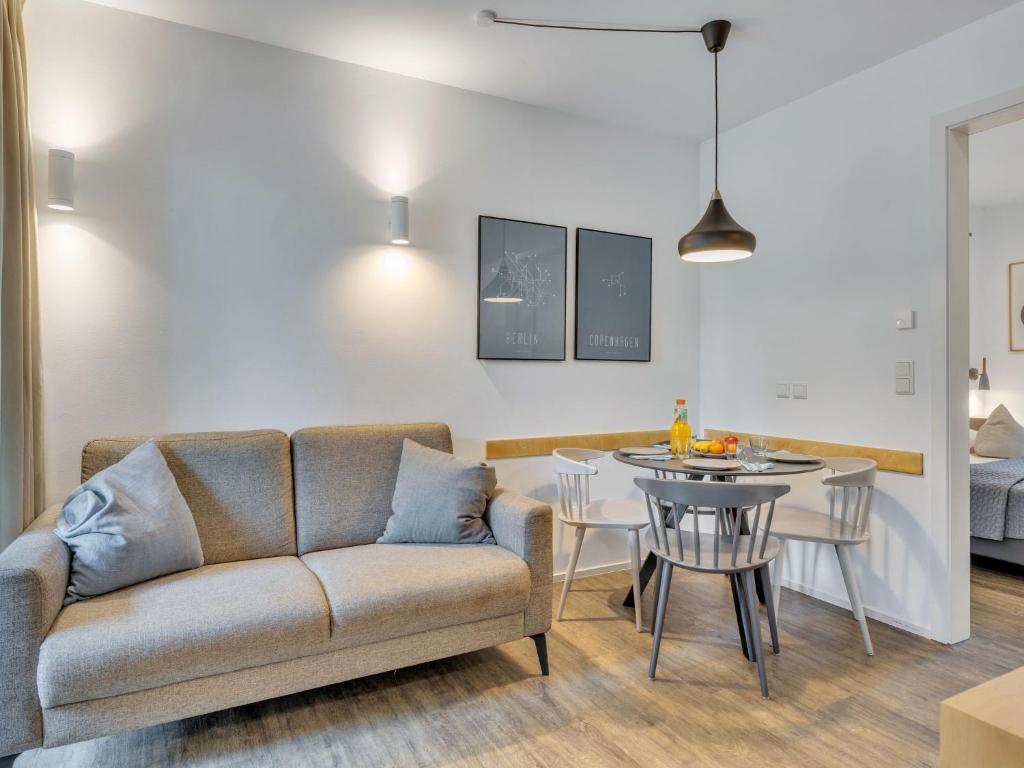 a living room with a couch and a table at Apartment Seetraum by Interhome in Lembruch