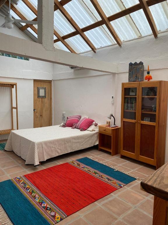 a bedroom with a bed with red pillows on it at Casa Kata in Zipolite