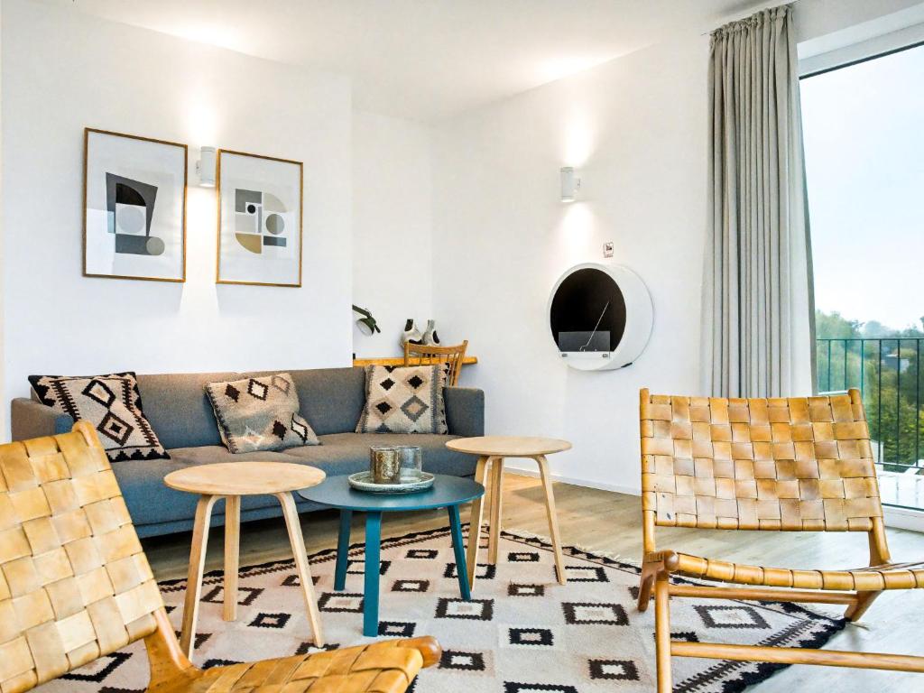 a living room with a couch and chairs at Apartment Penthouse Seeblick by Interhome in Lembruch