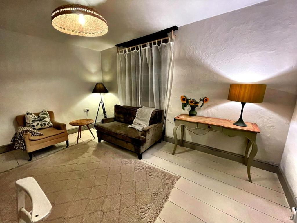 a living room with a couch and a table at The Locker, 2 bed apartment in Falmouth in Falmouth