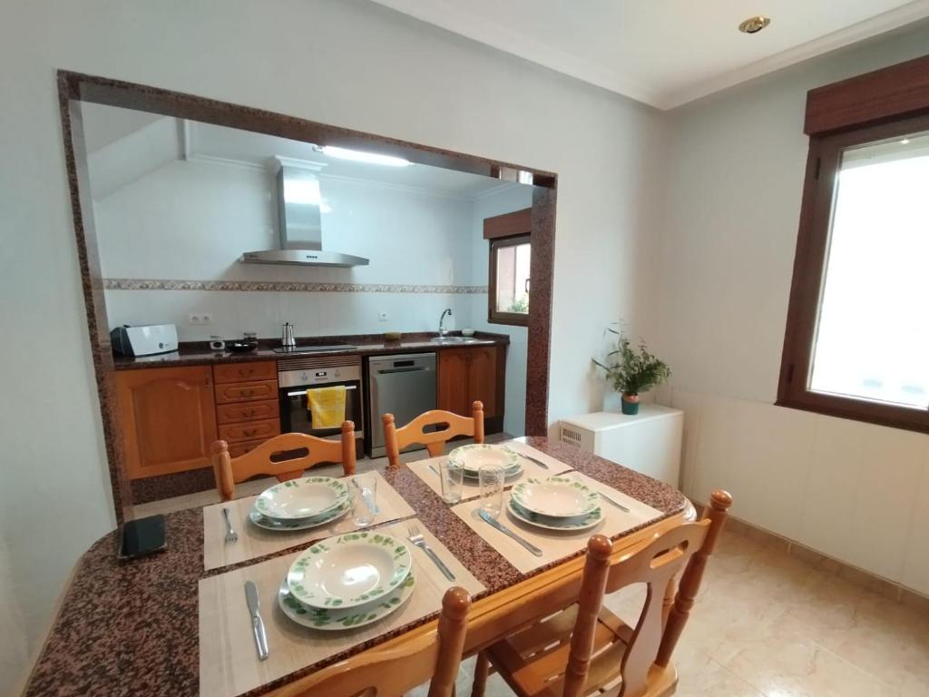 una sala da pranzo con un tavolo e una cucina di Casa natural redes 