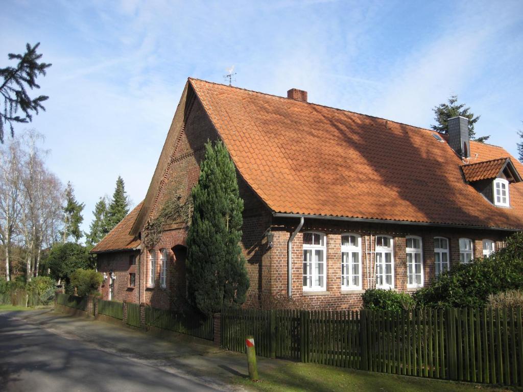 a brown brick house with a brown roof at Ferienwohnung In Ehemaliger Dorfschule Am Dorfrand in Bergen