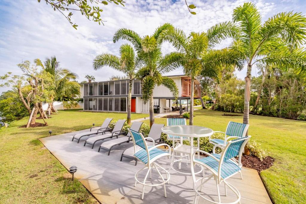 a patio with chairs and a table in front of a house at Waterfront Home by Ralph Twitchell in Sarasota