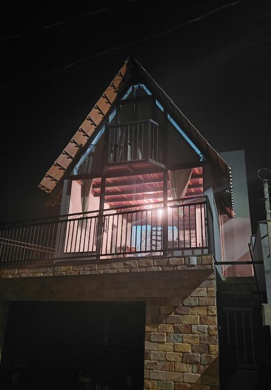 a house with a balcony at night at Chale Doce Refugio in Ouro Preto