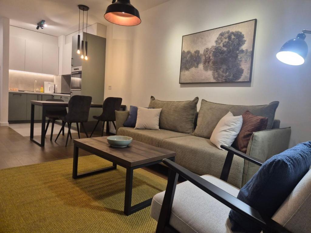 a living room with a couch and a table at Lastavica residence, modern luxury apartment with free garage in Novi Beograd