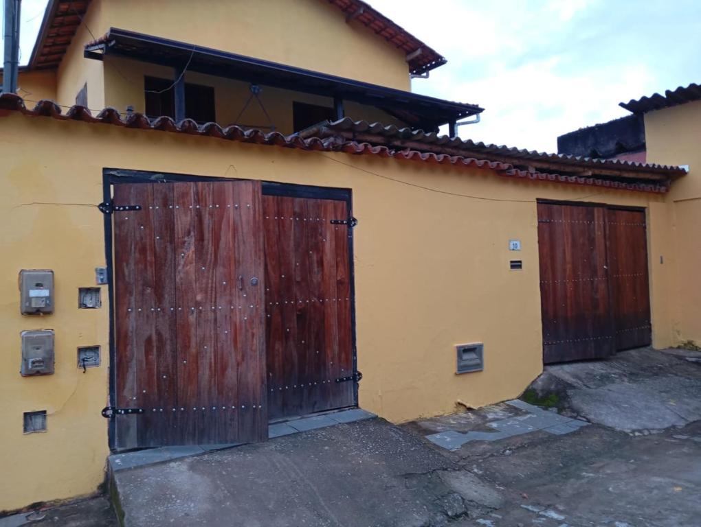 two wooden doors on the side of a house at Hostel da Luna in Paraty