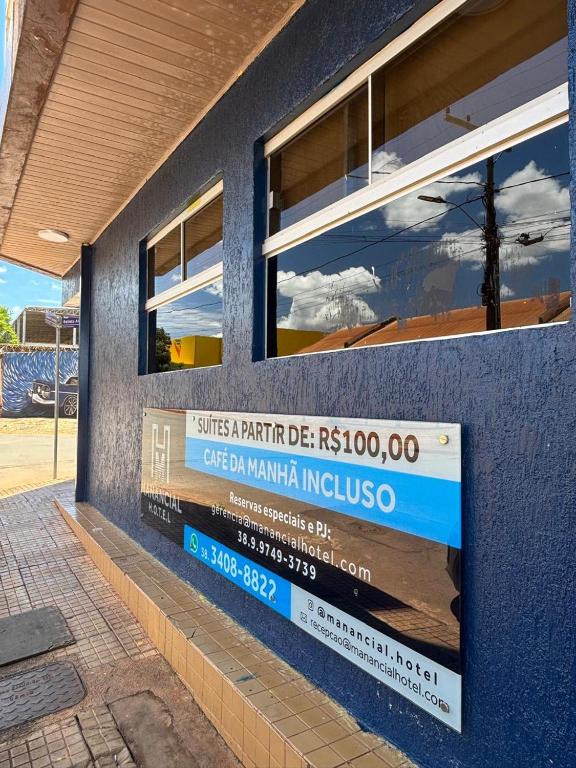 a blue building with a sign on the side of it at Manancial Hotel in Paracatu
