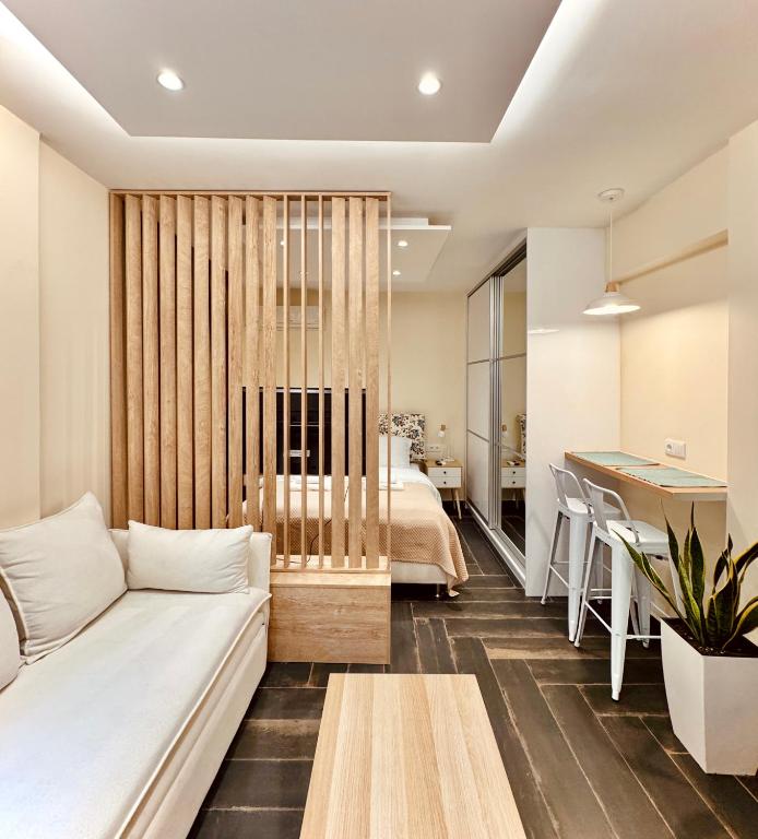 a living room with a white couch and a table at Ermou 18 Central Cozy Apartment in Athens