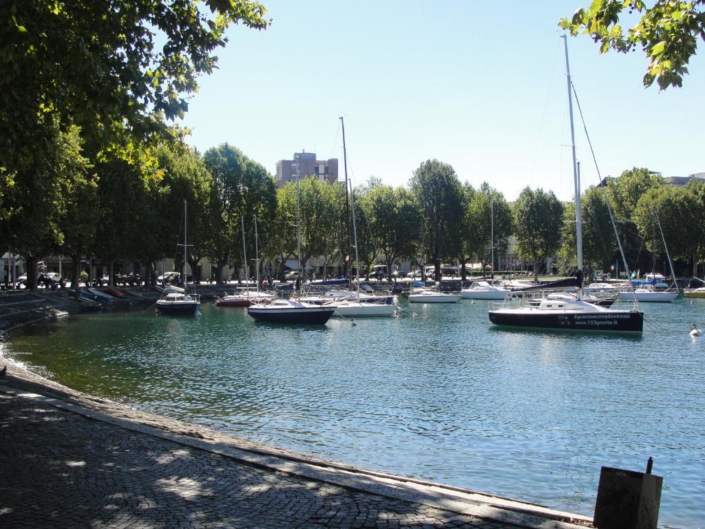 a bunch of boats are docked in a harbor at San Nicolo in Lecco