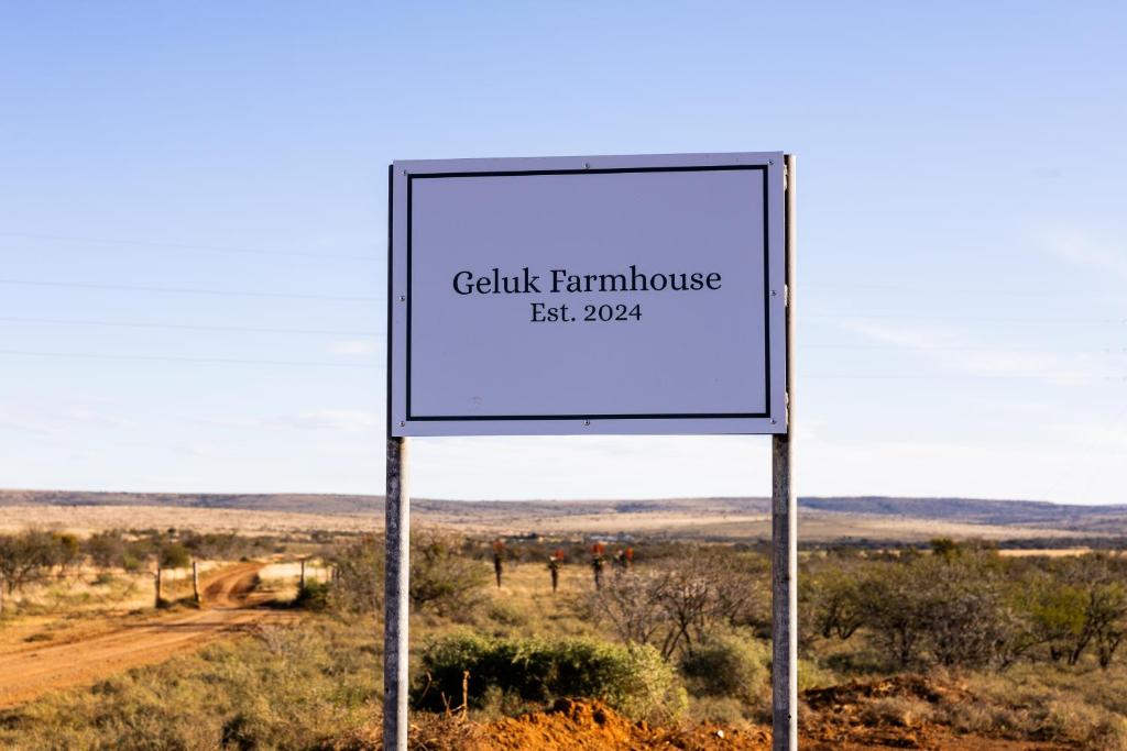 una señal en medio de un camino de tierra en Geluk Farmhouse, en Somerset East