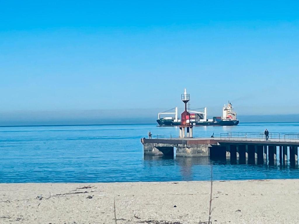 a dock on the water with a boat in the water at Love Gioia Tauro in Gioia Tauro