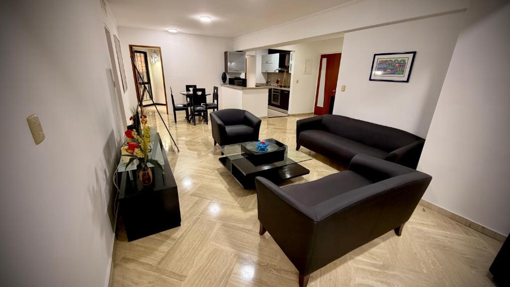 Una sala de estar con un sofá y sillas y una mesa. en Apartamento en Campo Alegre, Chacao, Caracas, en Caracas