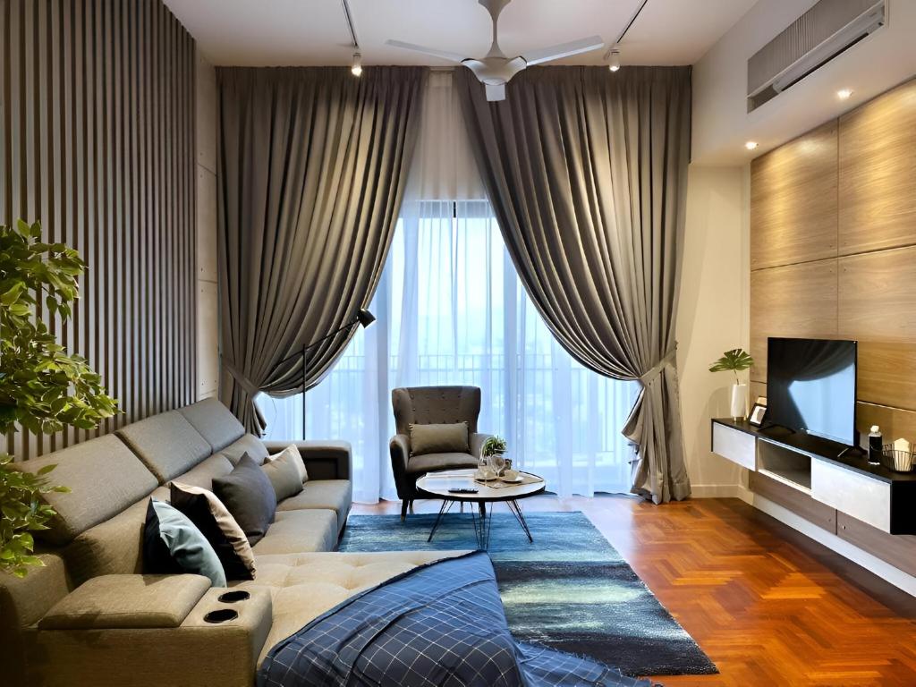 a living room with a couch and a table at Suites Apartment At The Mews KLCC in Kuala Lumpur