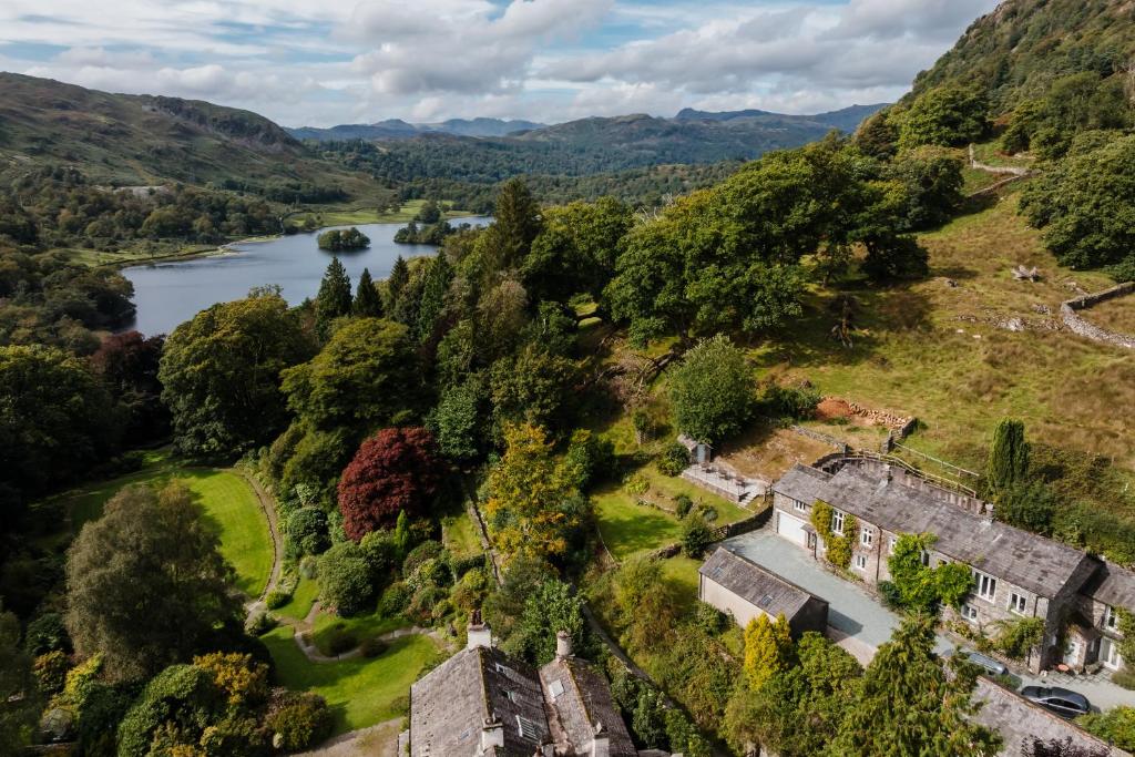 an aerial view of a house on a hill next to a river at 2 Hart Head Barn, Renovated Barn, Ambleside in Rydal