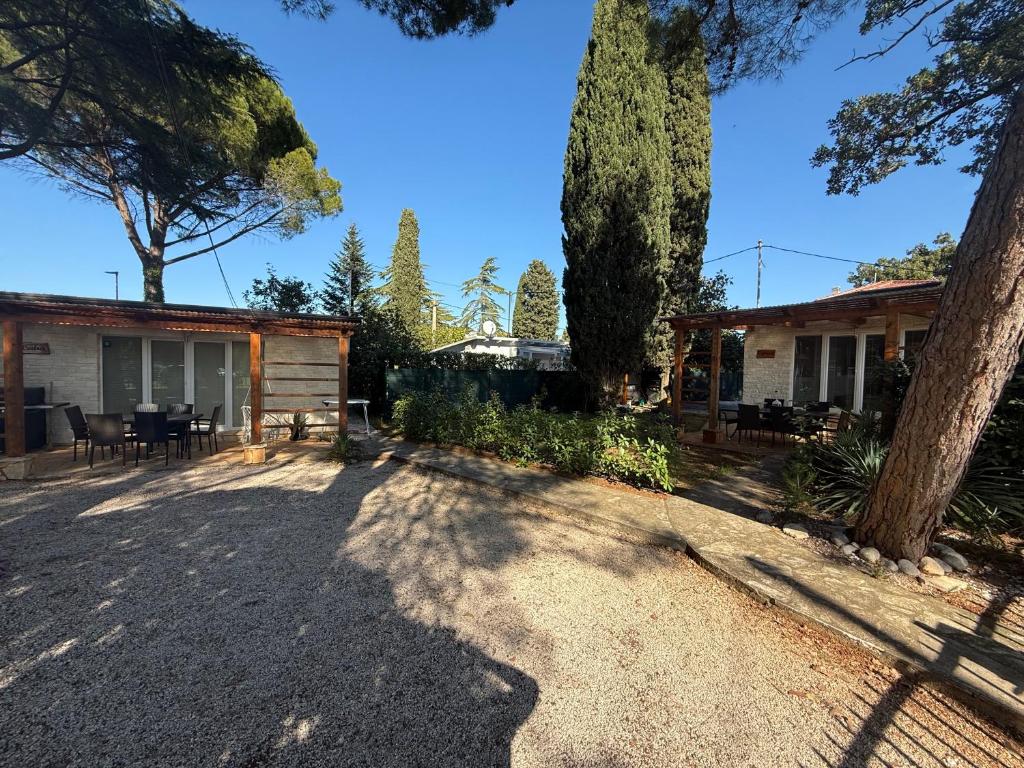 ein Haus mit schattiger Auffahrt und Bäumen in der Unterkunft Adriatic Houses Borse in Bašanija