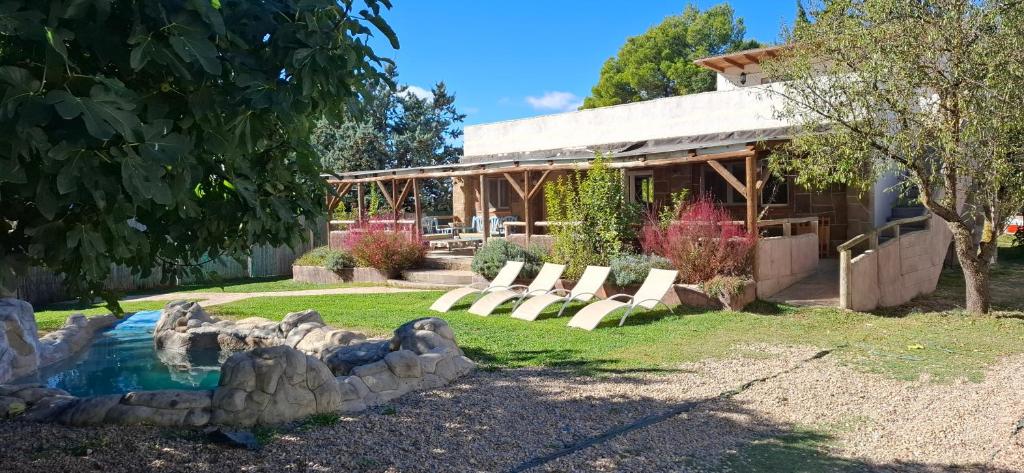 a group of chairs sitting in front of a house at Casa Mirlo in Montmesa