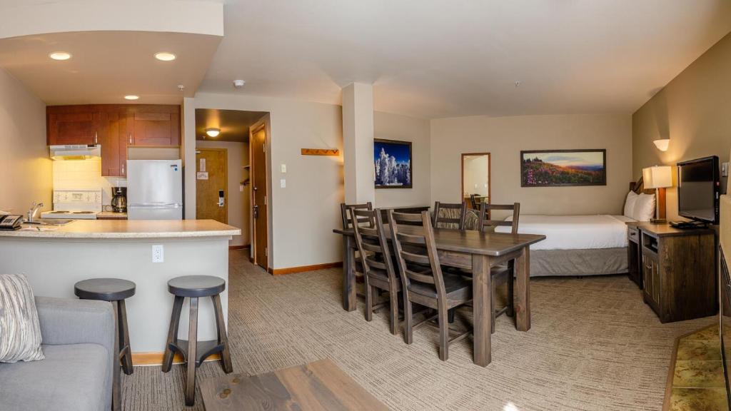 a hotel room with a kitchen and a bedroom at Cahilty #346 home in Sun Peaks