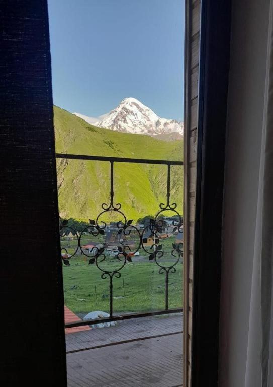 a view of a mountain from a room with a window at Mountain flower cottage in Kazbegi