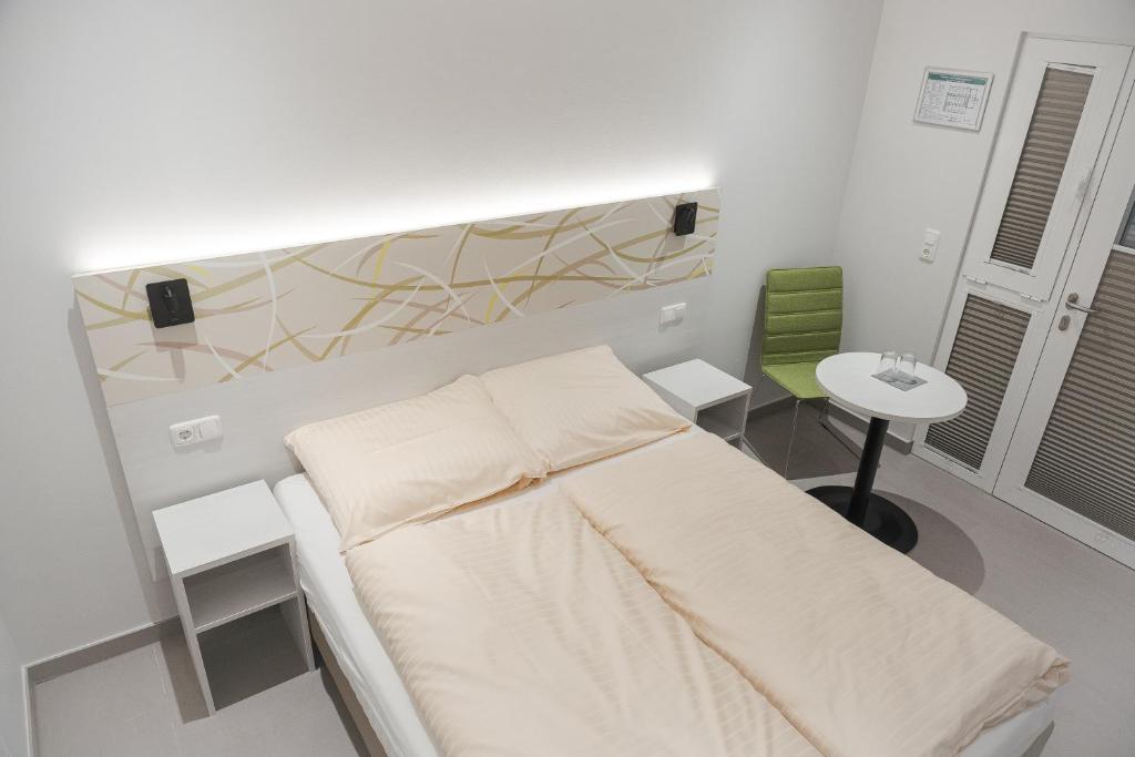 a hospital room with a bed and a table at C&M Hotel in Hamburg