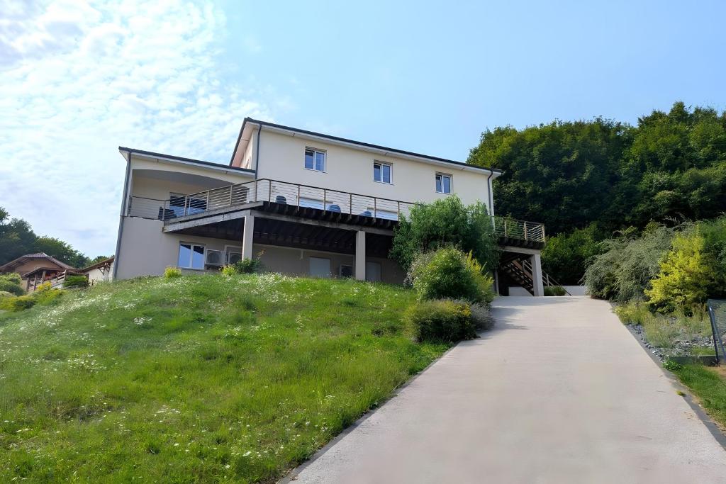 a house on a hill with a walkway at Villa des ermites in Favières