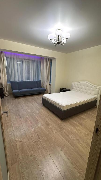 a bedroom with a bed and a chandelier at Wohnung Alter Hof in Künzell