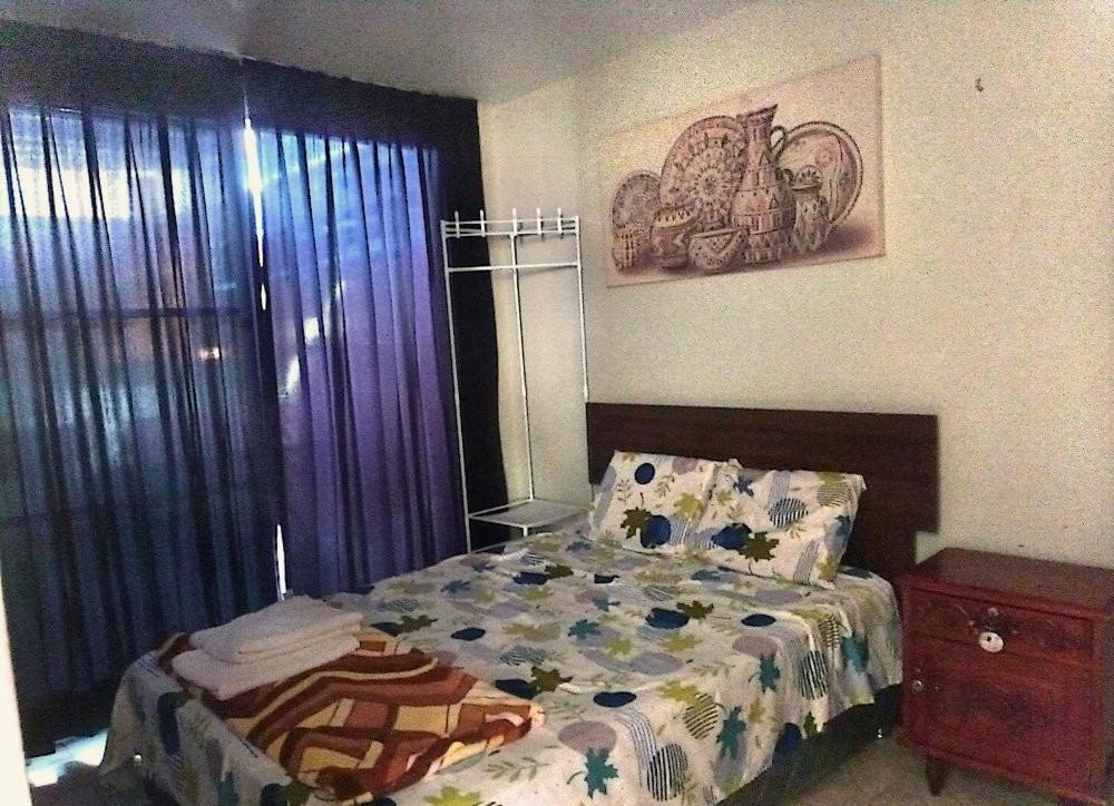 une chambre avec un lit avec une couette dessus dans l'établissement Casa en Lambayeque, à Lambayeque