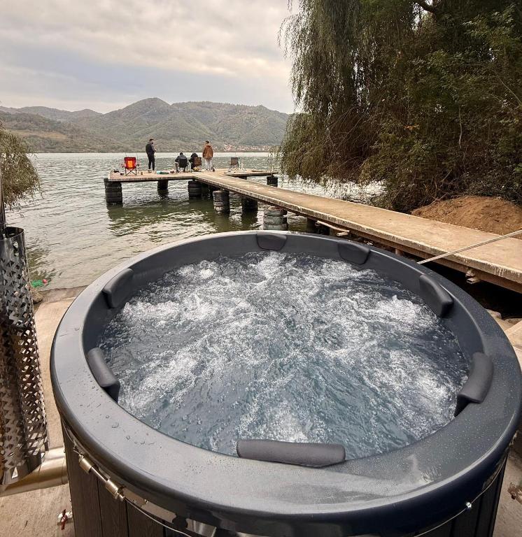 a hot tub in the water next to a dock at Orsova Gratca 164 in Orşova