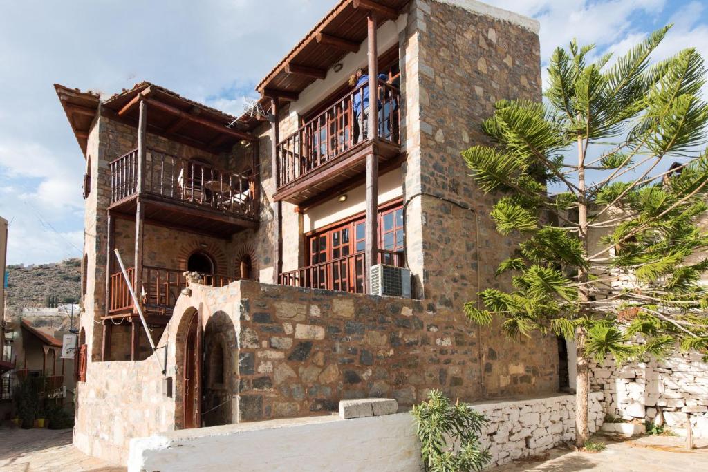 a brick house with two balconies on top of it at Ferienhaus In Mavrikiano Mit Privatem Pool in Elounda